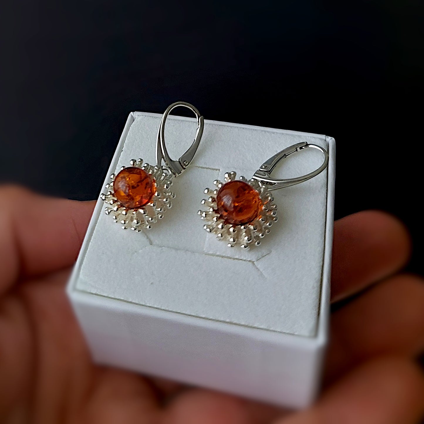 Handmade sterling silver dangle earrings with cognac Baltic amber in a modern flower design