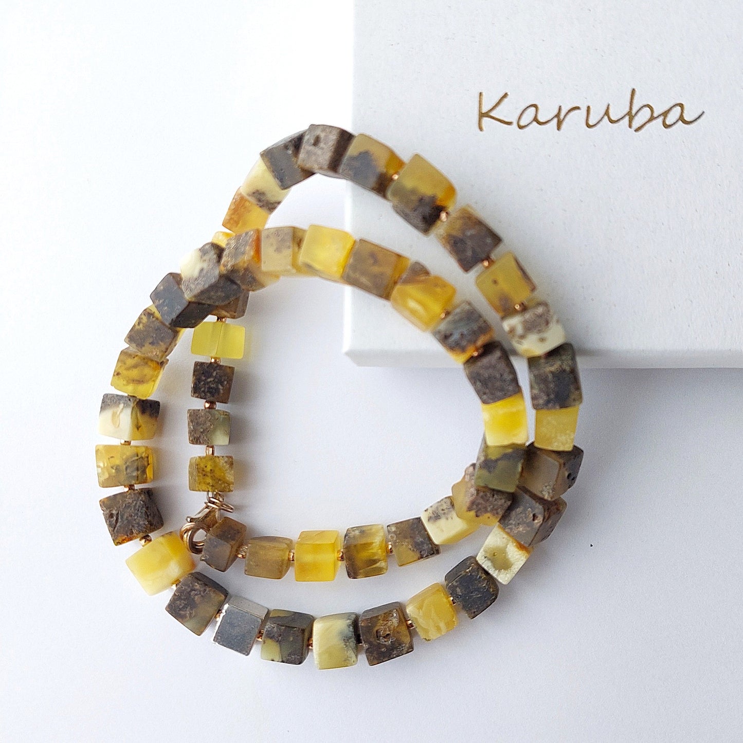 Handmade necklace with natural raw Baltic amber cube beads in yellow and brown shades, featuring a 925 sterling silver cube