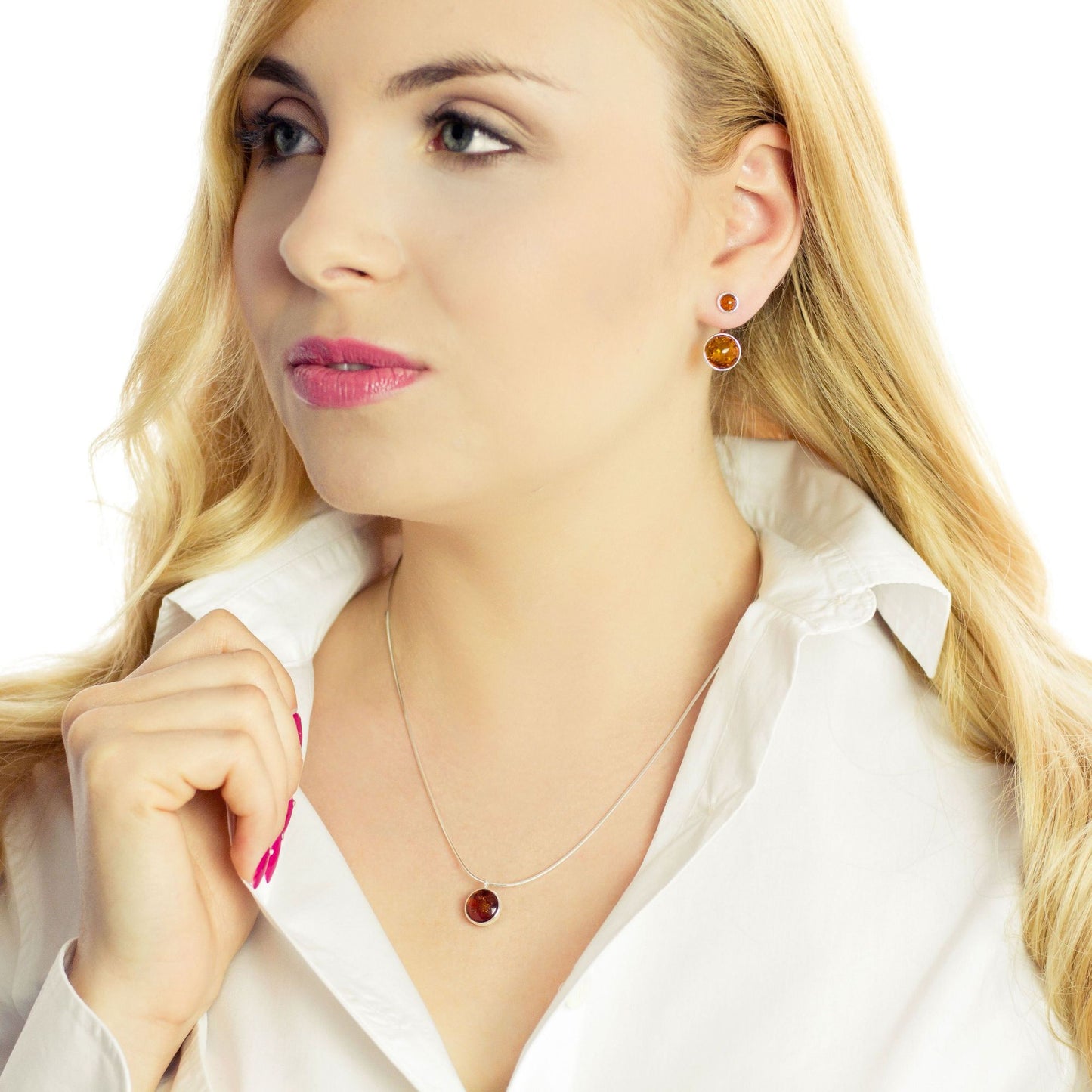 Two-piece sterling silver earrings with round Baltic amber stones, worn as classic studs or ear jackets. Handmade modern jewelry with natural cognac amber.