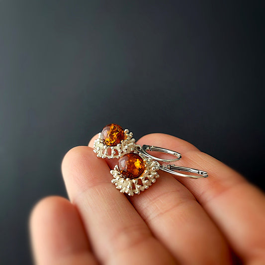 Handmade sterling silver dangle earrings with cognac Baltic amber in a modern flower design