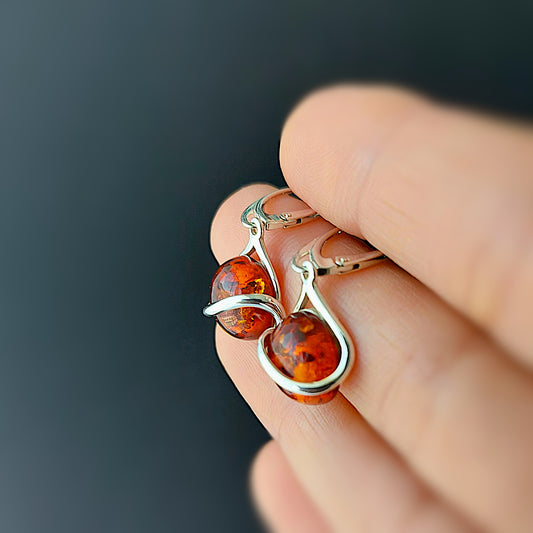 Sterling silver dangle earrings with round Baltic amber stones on English leverback hooks